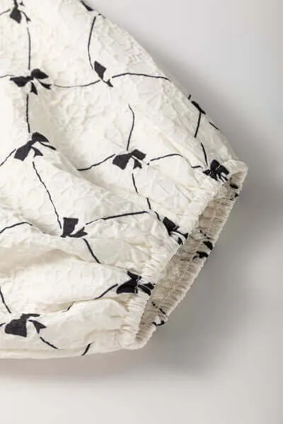 Got the Allure Bow Print Tie Neck Bubble Sleeve Dress in White and Black