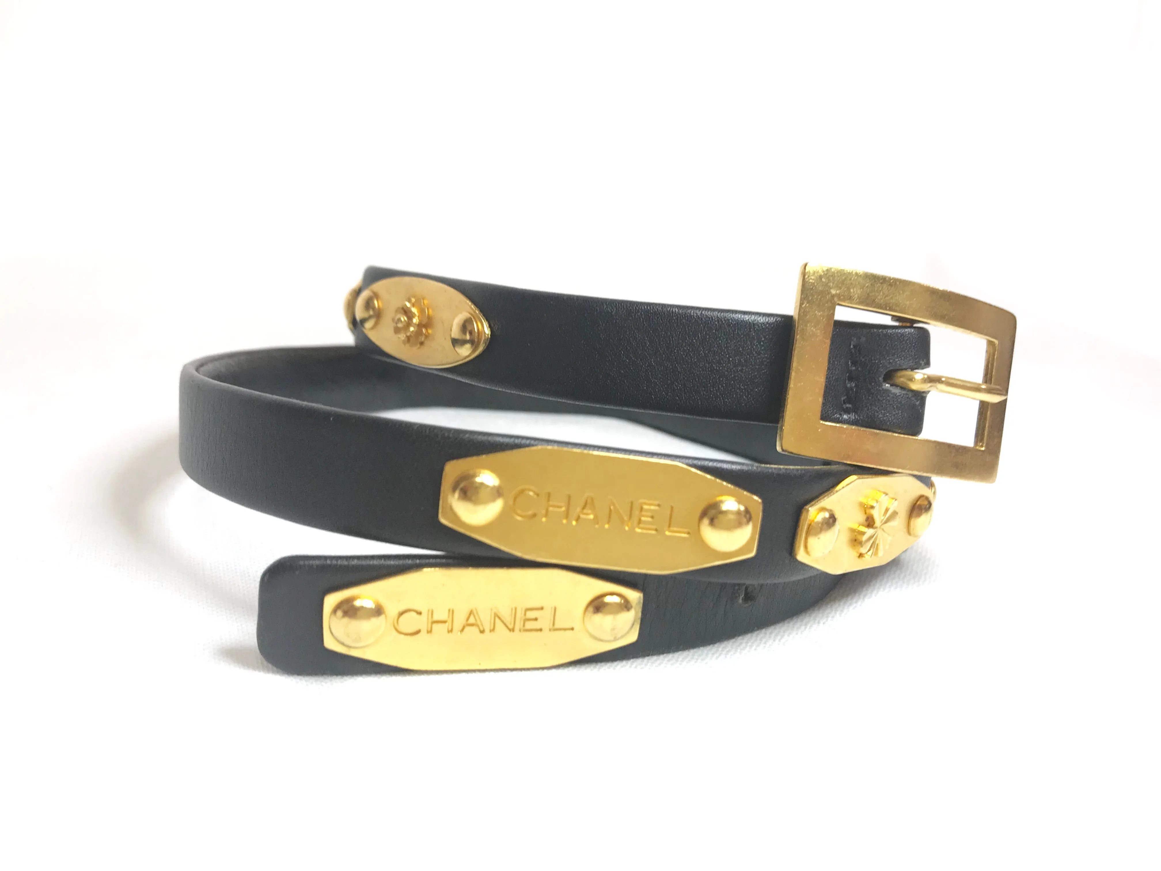 Vintage CHANEL black belt with golden buckle and iconic logo motifs, CC mark, camellia flower, turtle, perfume, clover. R0410113
